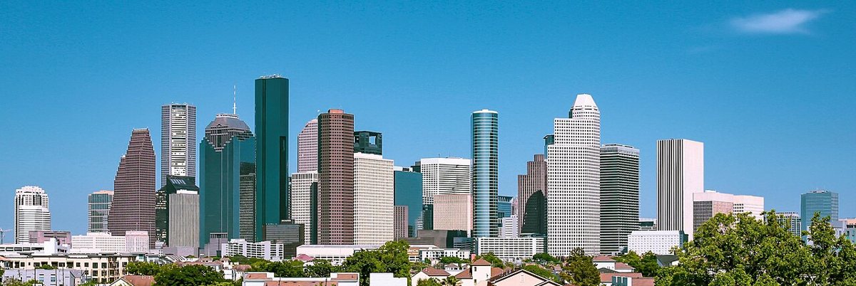 Downtown Houston skyline beneath a blue sky