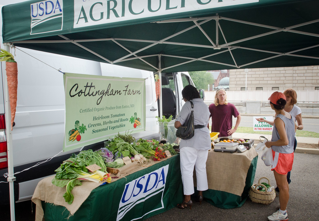 Cottingham Farm staff talking with shoppers at the USDA Farmers Market