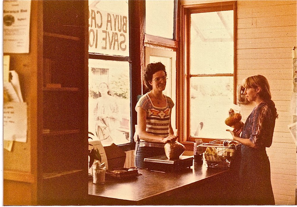 Mina behind the counter at People's Food Co-op in 1982